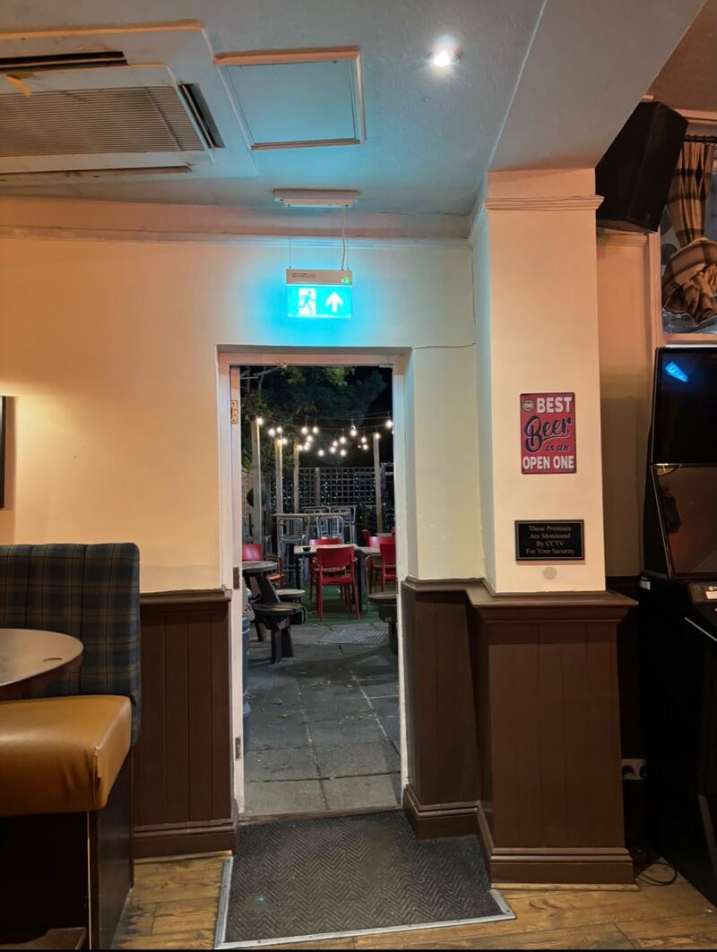 The doorway out to the beer garden at O'Farrell's with festoon lights strung above